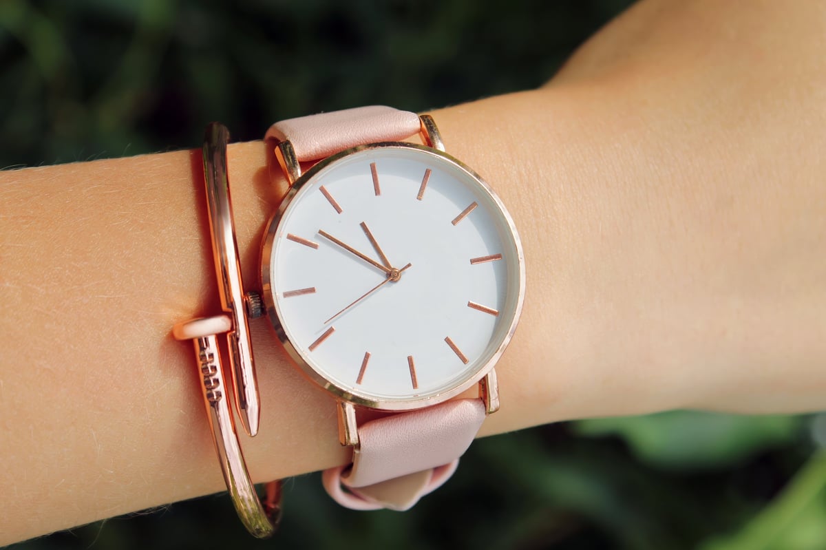 Rose gold watch with white face and pink leather strap
