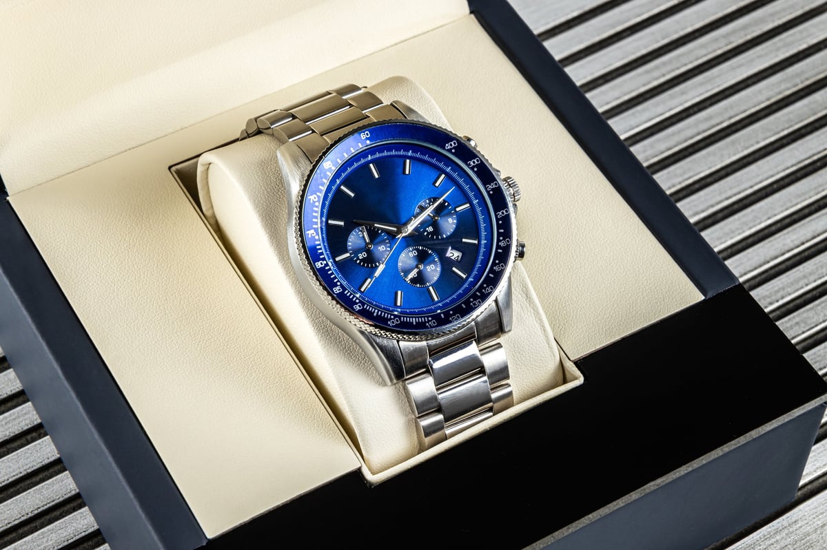 Stylish men's wrist watch with metallic strap, blue face, chronograph