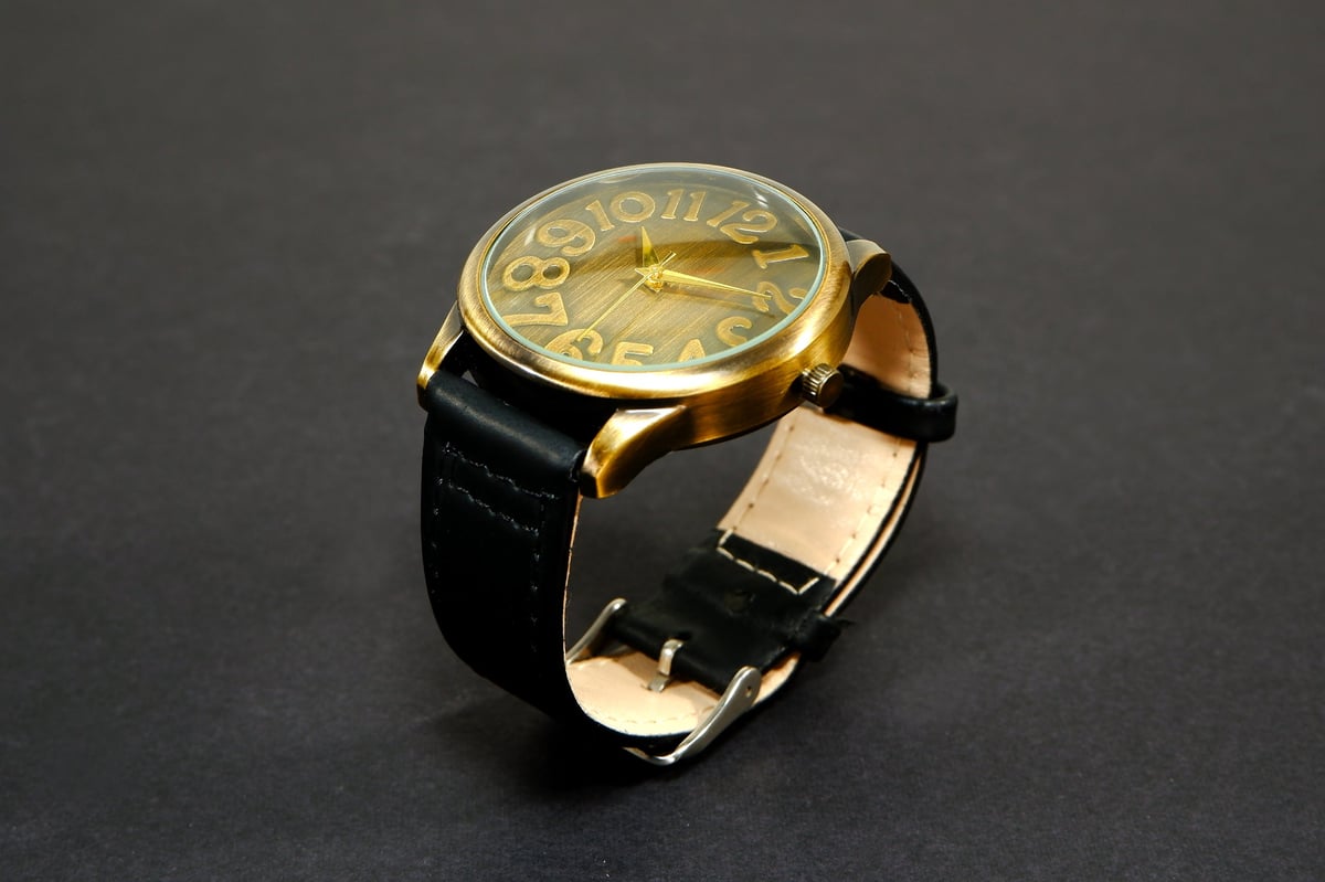 Vintage wristwatch with brushed brass casing and genuine leather strap